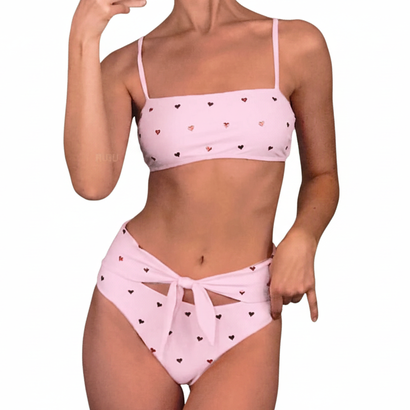 Pink high-waist bikini with a heart print pattern and an adjustable bow on the bottoms