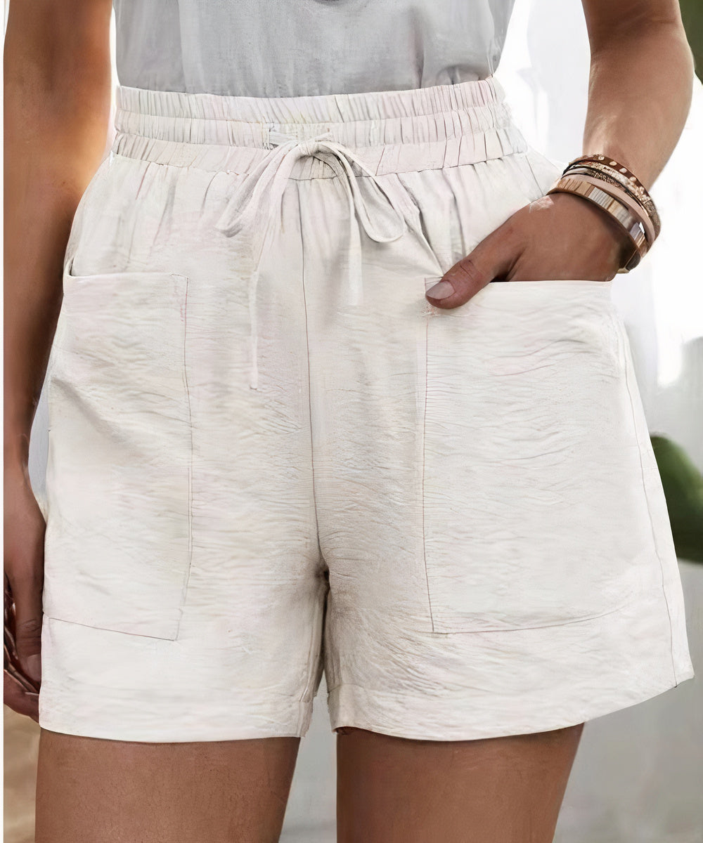 High-waist women's shorts in a range of vibrant colours including purple, orange, and green