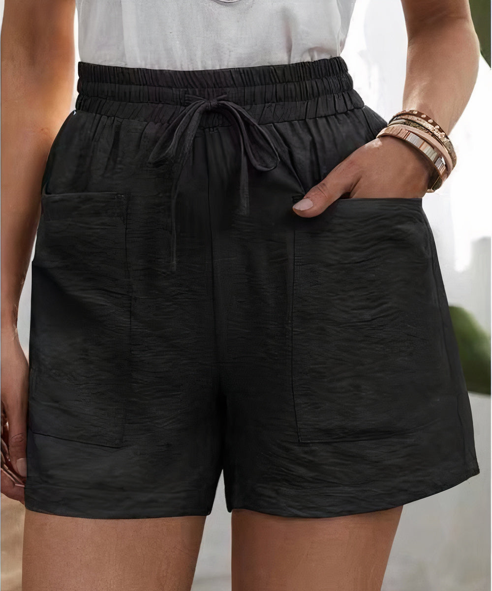 High-waist women's shorts in a range of vibrant colours including purple, orange, and green