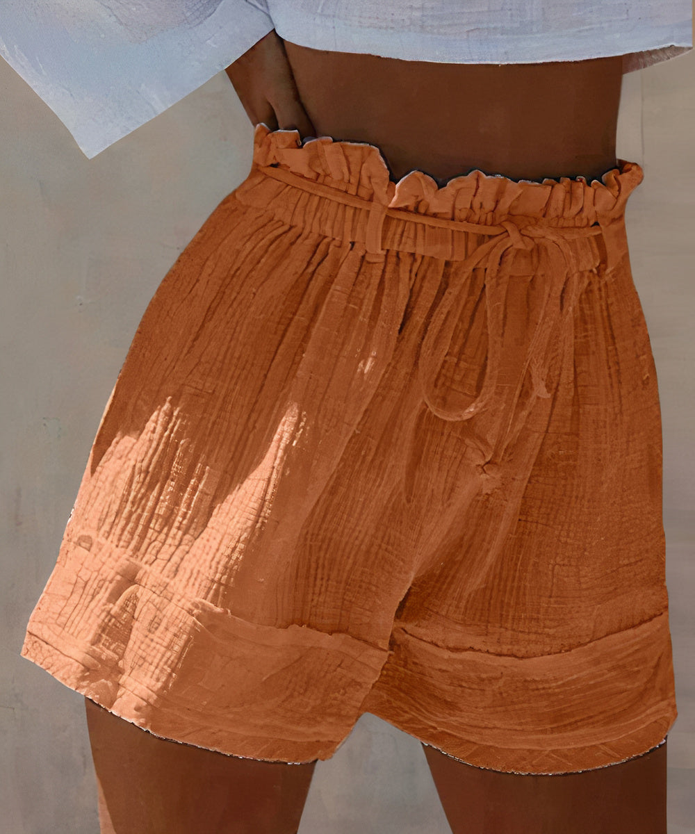 High-waist women's shorts in a range of vibrant colours including purple, orange, and green