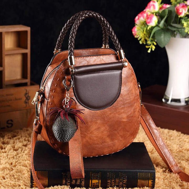 A woman carrying a roomy versatile tote bag with a rich finish over her shoulder