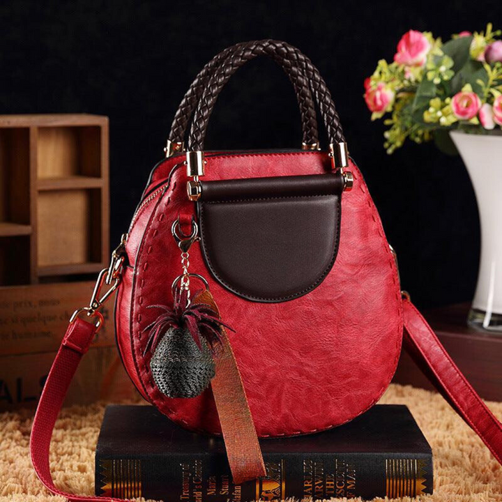 A woman carrying a roomy versatile tote bag with a rich finish over her shoulder
