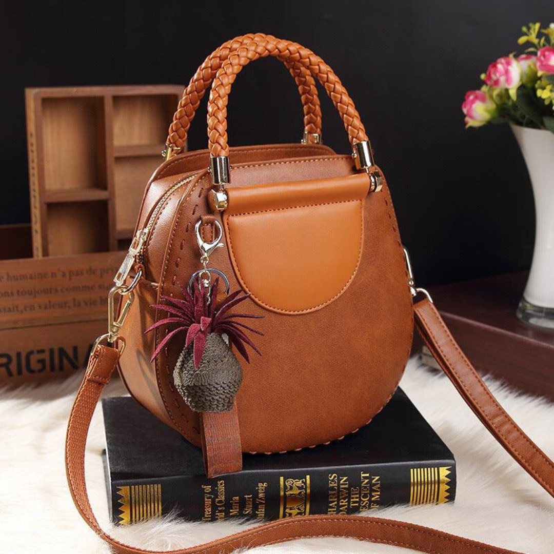 A woman carrying a roomy versatile tote bag with a rich finish over her shoulder