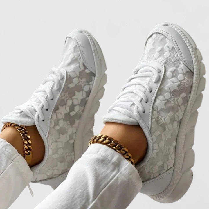 A woman wearing clean white cushioned comfort trainers