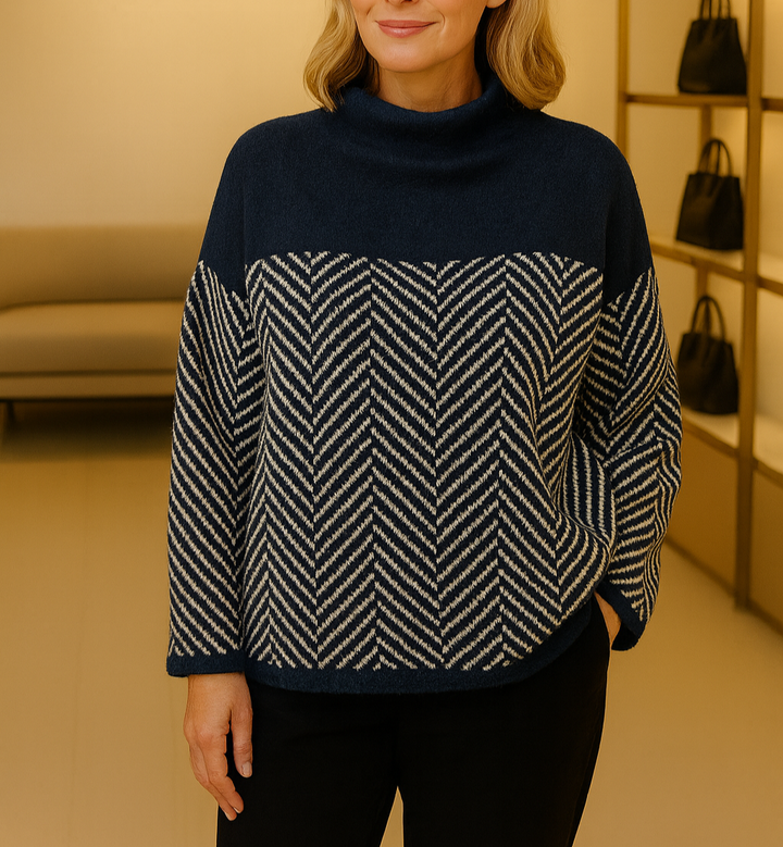 A woman wearing a zigzag-pattern funnel neck jumper styled elegantly for an autumn day out.