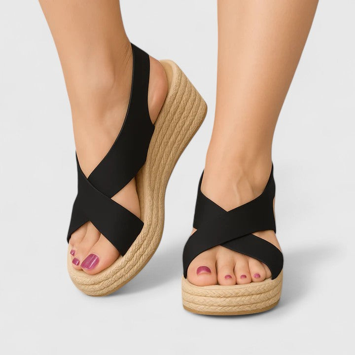 A woman in white crossover platform sandals standing comfortably, feet relaxed and supported.