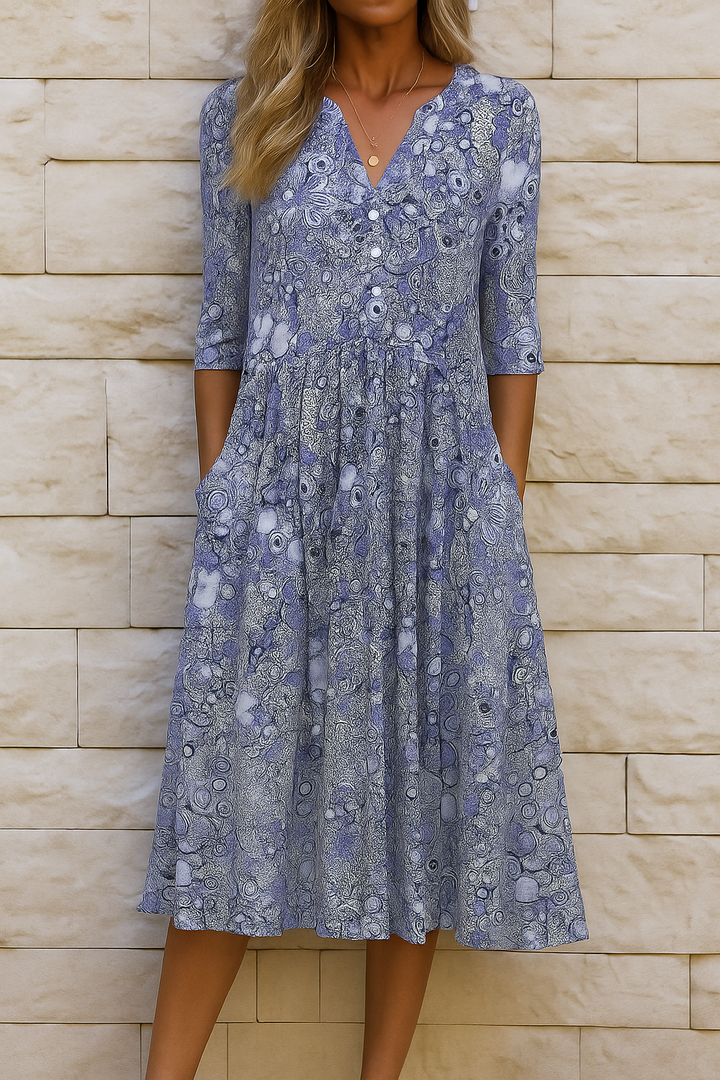 Woman wearing the Laura elegant V-neck dress with three-quarter sleeves, walking through a city street.