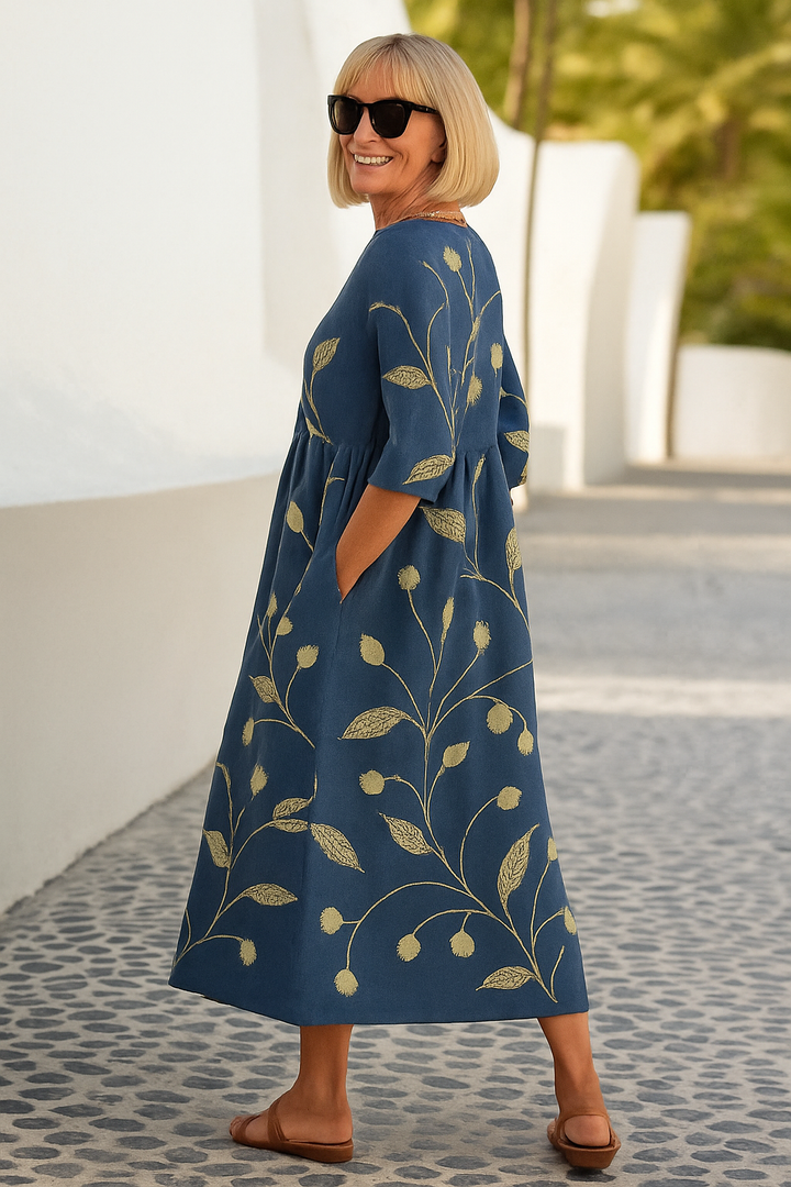 A woman wearing the Una relaxed floral midi dress with an A-line skirt, out for a daytime stroll.