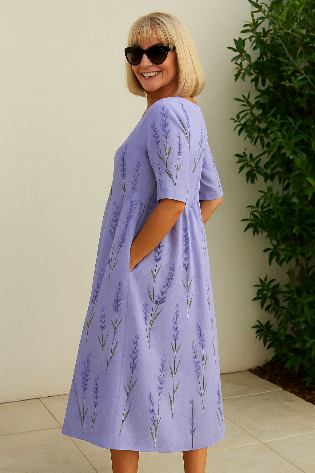 A woman wearing the Una relaxed floral midi dress with an A-line skirt, out for a daytime stroll.