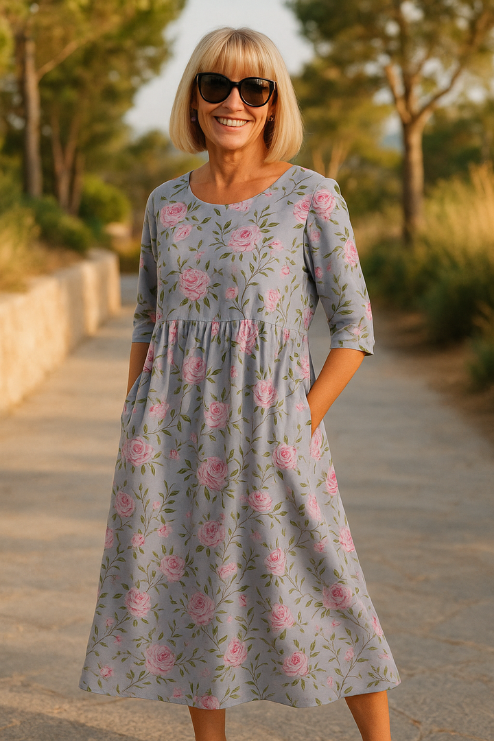 A woman wearing the Una relaxed floral midi dress with an A-line skirt, out for a daytime stroll.