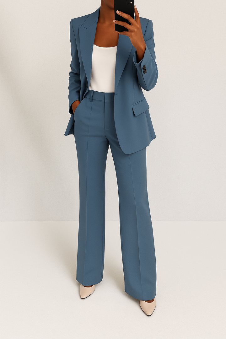 A woman wearing a tailored slim-fit blazer with matching trousers.