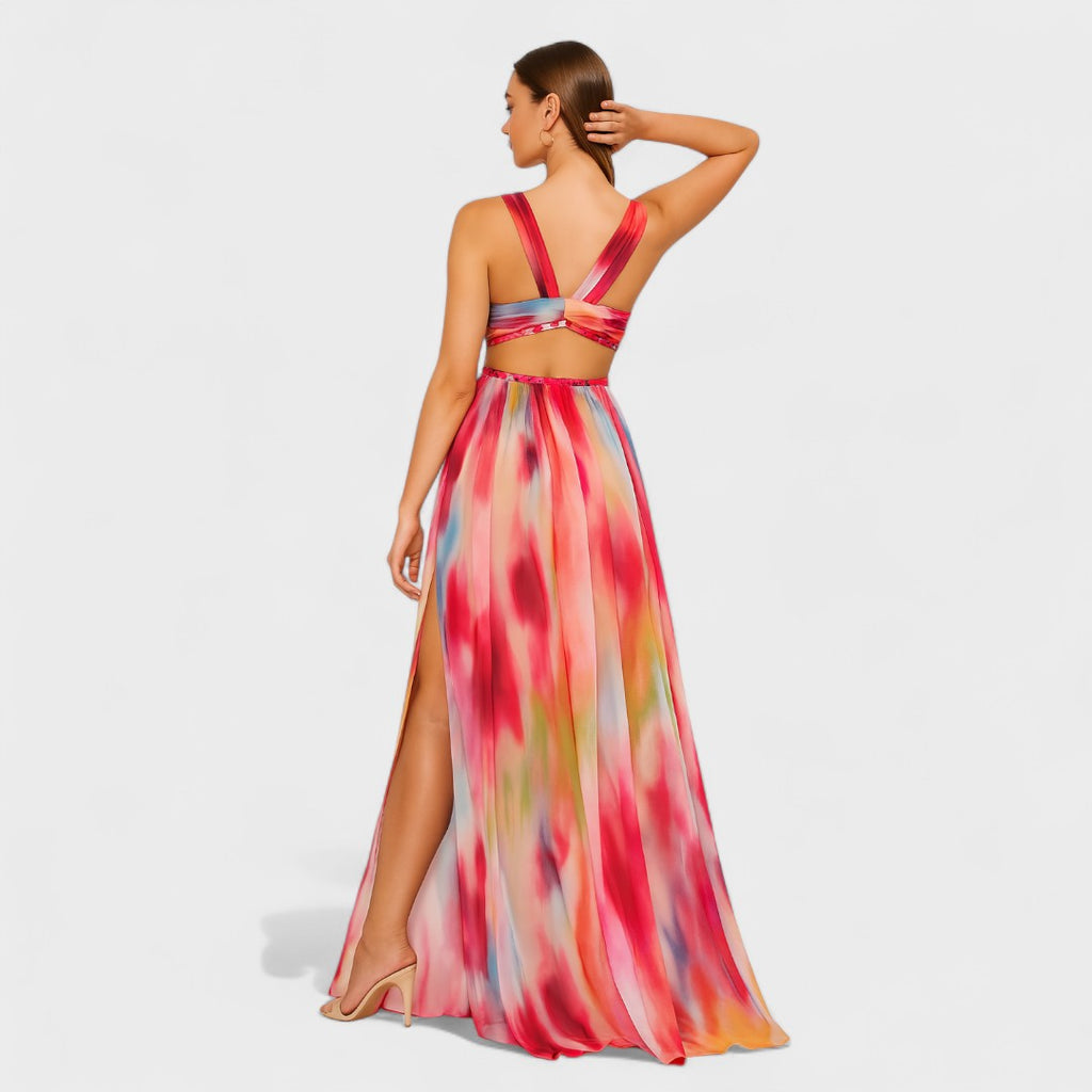 A fluid printed summer dress in a vibrant artistic pattern, styled for an outdoor occasion