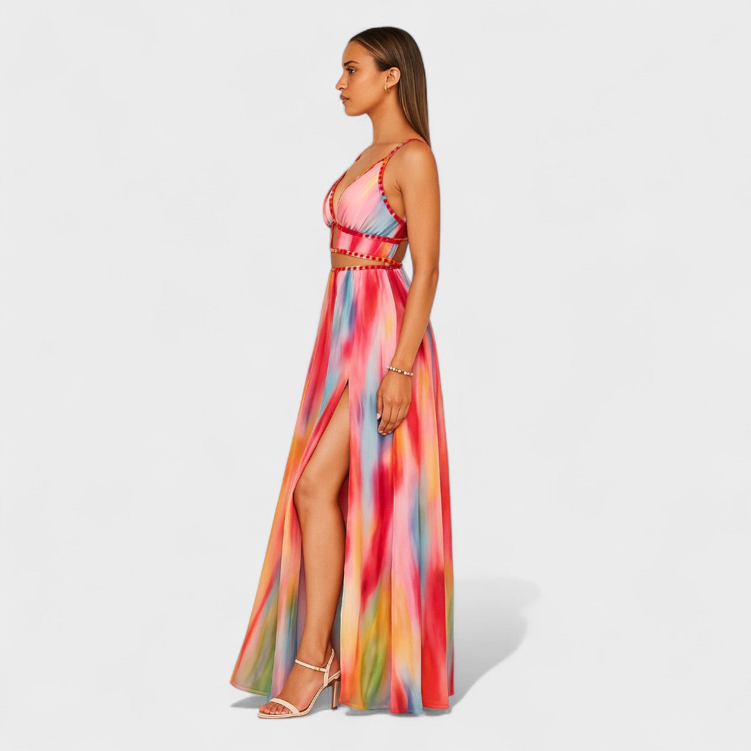 A fluid printed summer dress in a vibrant artistic pattern, styled for an outdoor occasion