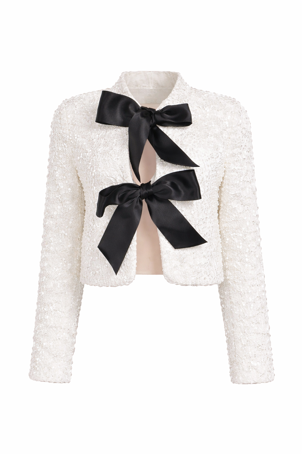 White shimmer blazer with large black bow detail and a cropped, structured cut