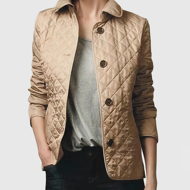 A woman wearing an autumn jacket over a top, layered for a crisp day in town.