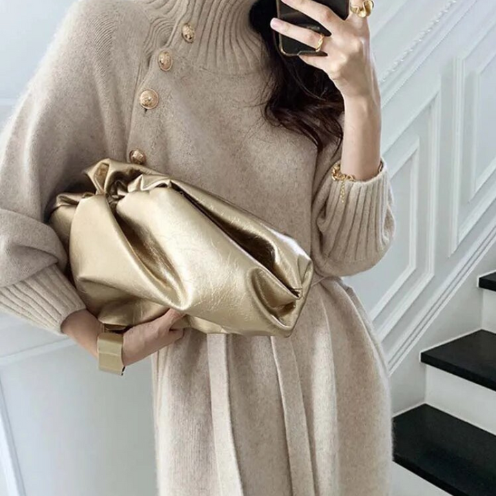 Woman in the Rosa cosy wrap dress with gold-tone buttons and a waist tie, holding a warm drink at home.