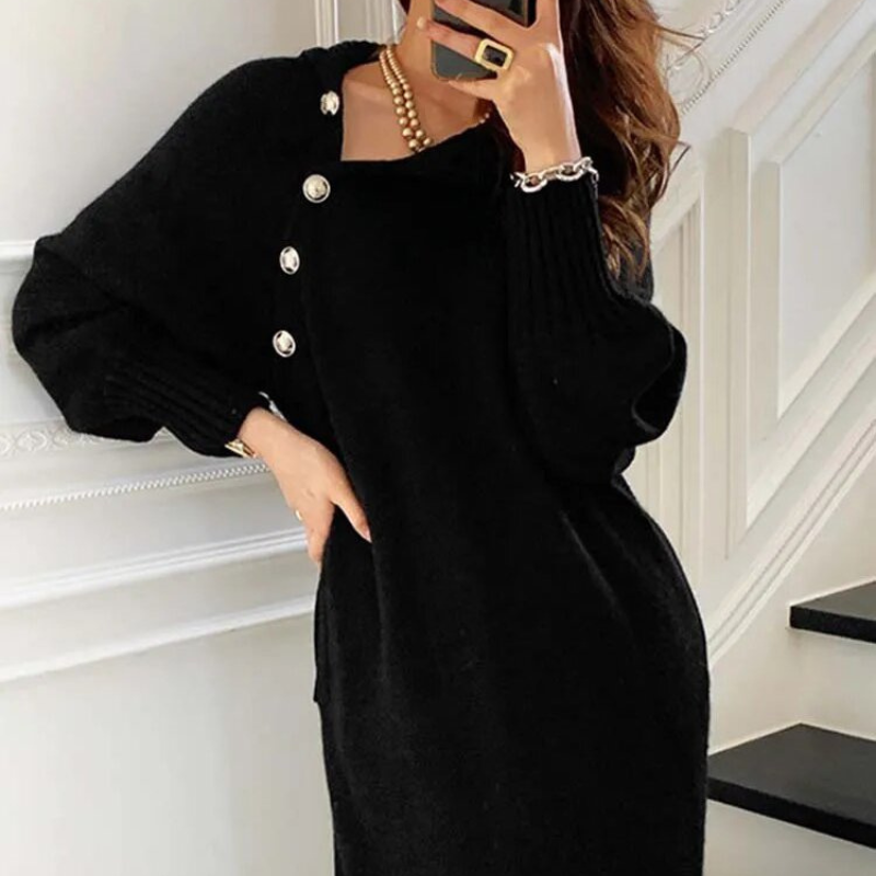 Woman in the Rosa cosy wrap dress with gold-tone buttons and a waist tie, holding a warm drink at home.