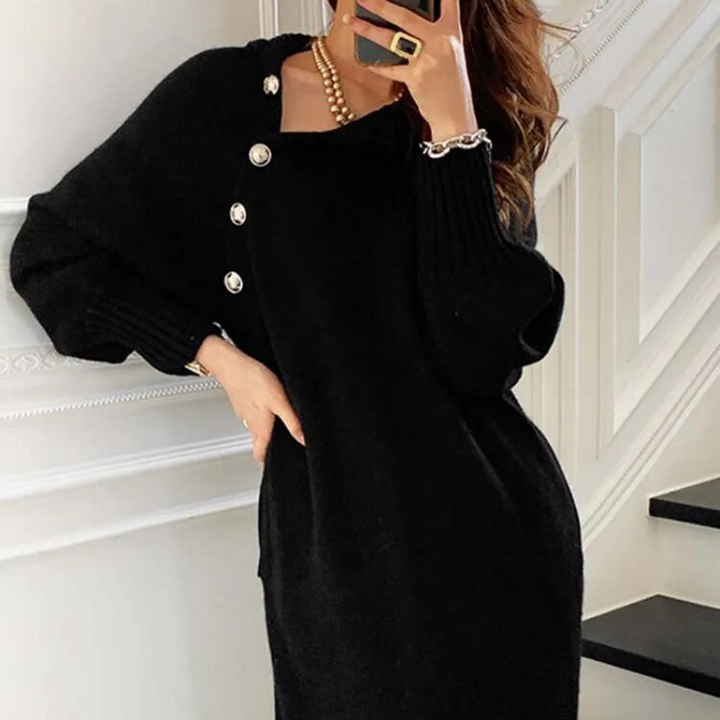 Woman in the Rosa cosy wrap dress with gold-tone buttons and a waist tie, holding a warm drink at home.