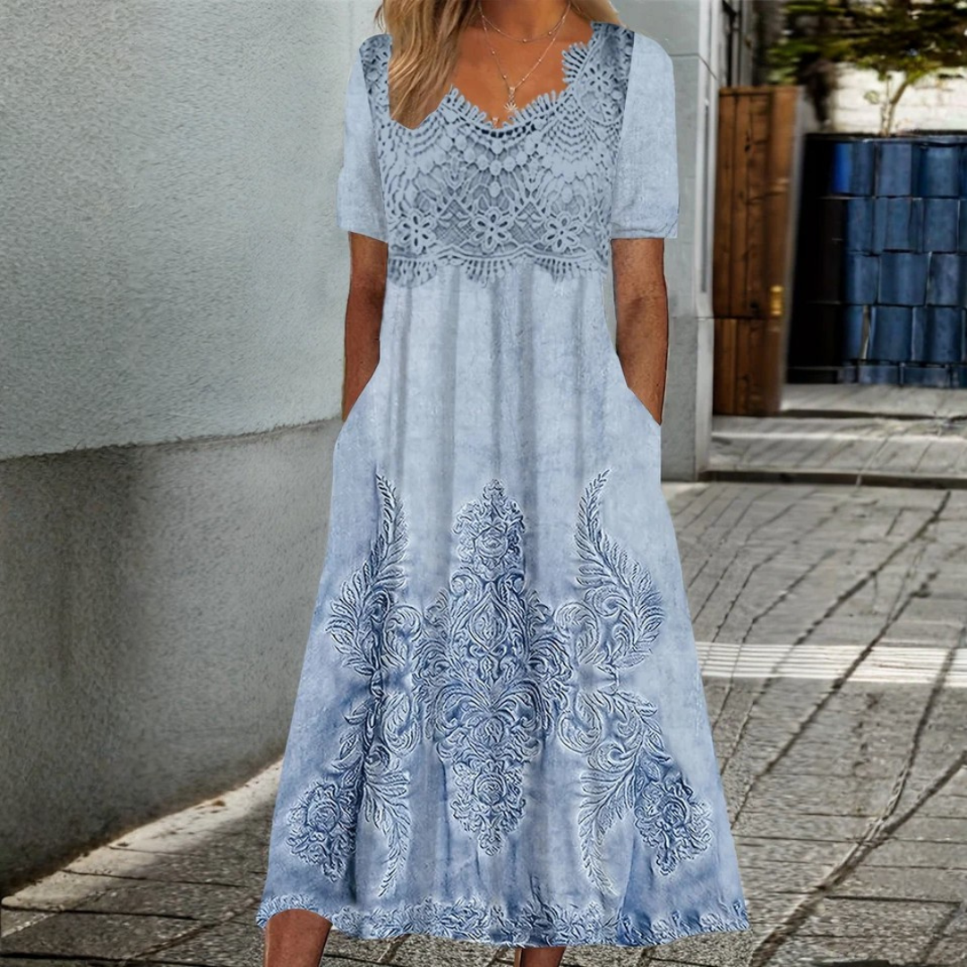 Woman wearing the Nora soft floral midi dress at a garden gathering.