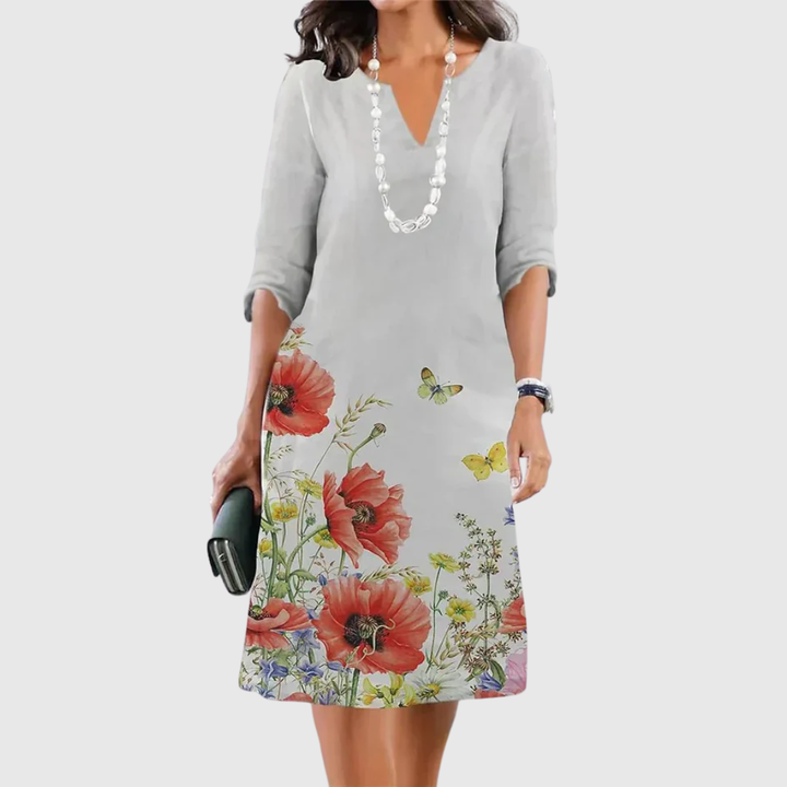Woman wearing the Kathleen floral A-line dress in ivory, dressed for a daytime lunch.