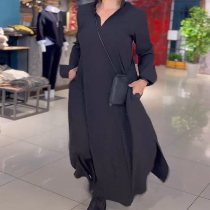 Woman wearing the Sarah relaxed maxi dress with revere collar, standing by a doorway.