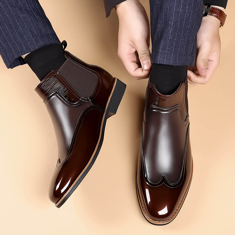 Men's brown classic Chelsea boots with elastic side panels and a smooth structured upper