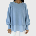 Layered knit top in light blue with a soft structured upper and loose floaty hem