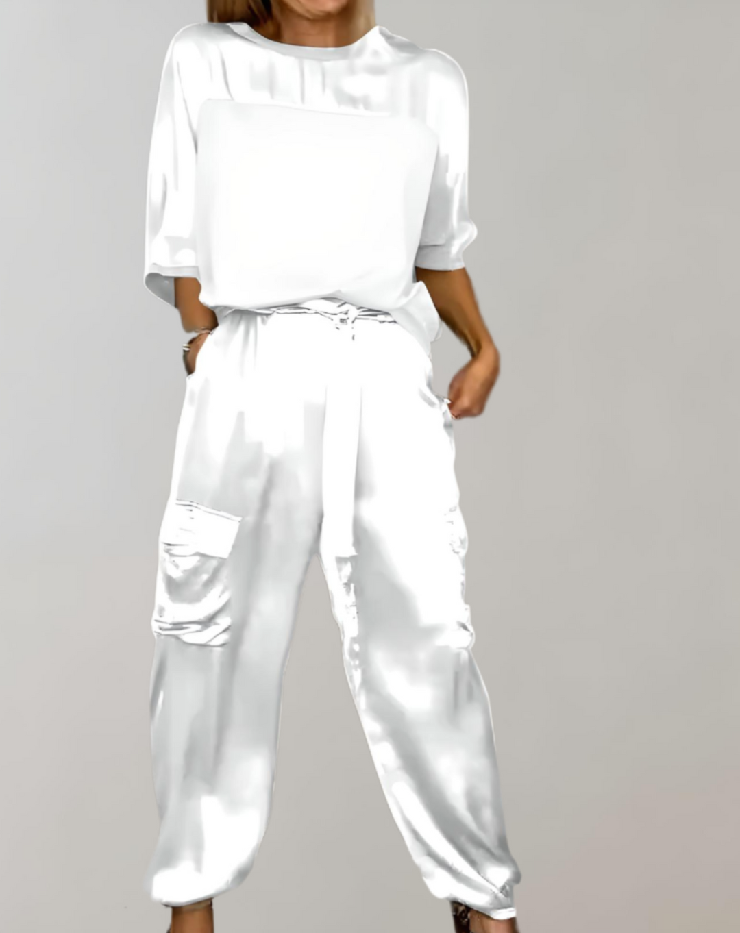 A woman wearing a silky-finish cargo top and trousers lounge set with pockets.