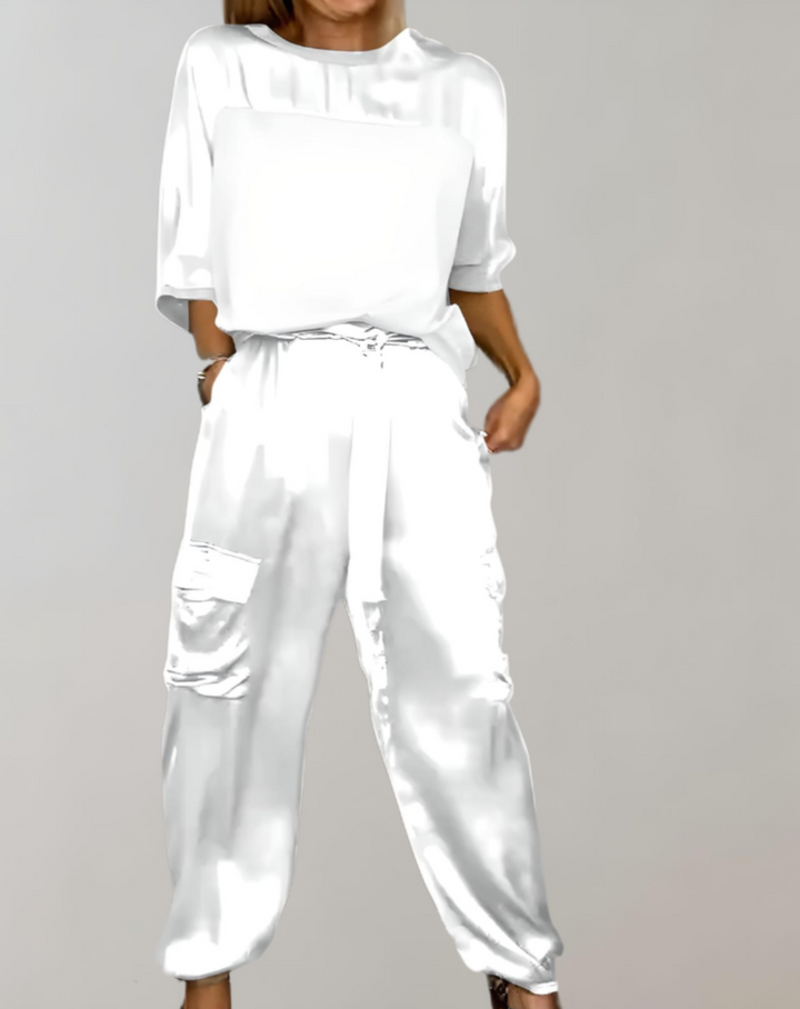 A woman wearing a silky-finish cargo top and trousers lounge set with pockets.