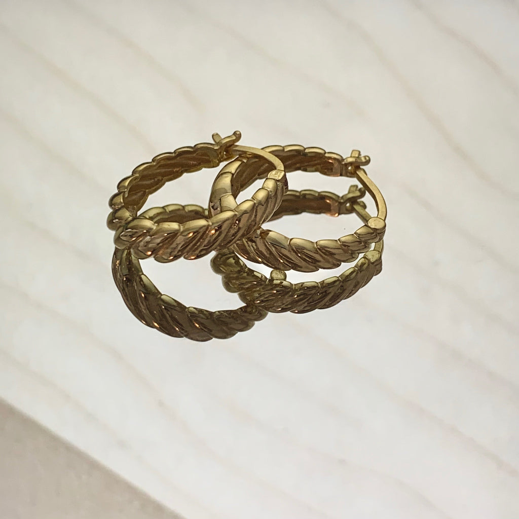 Gold twisted side ring earrings with polished finish