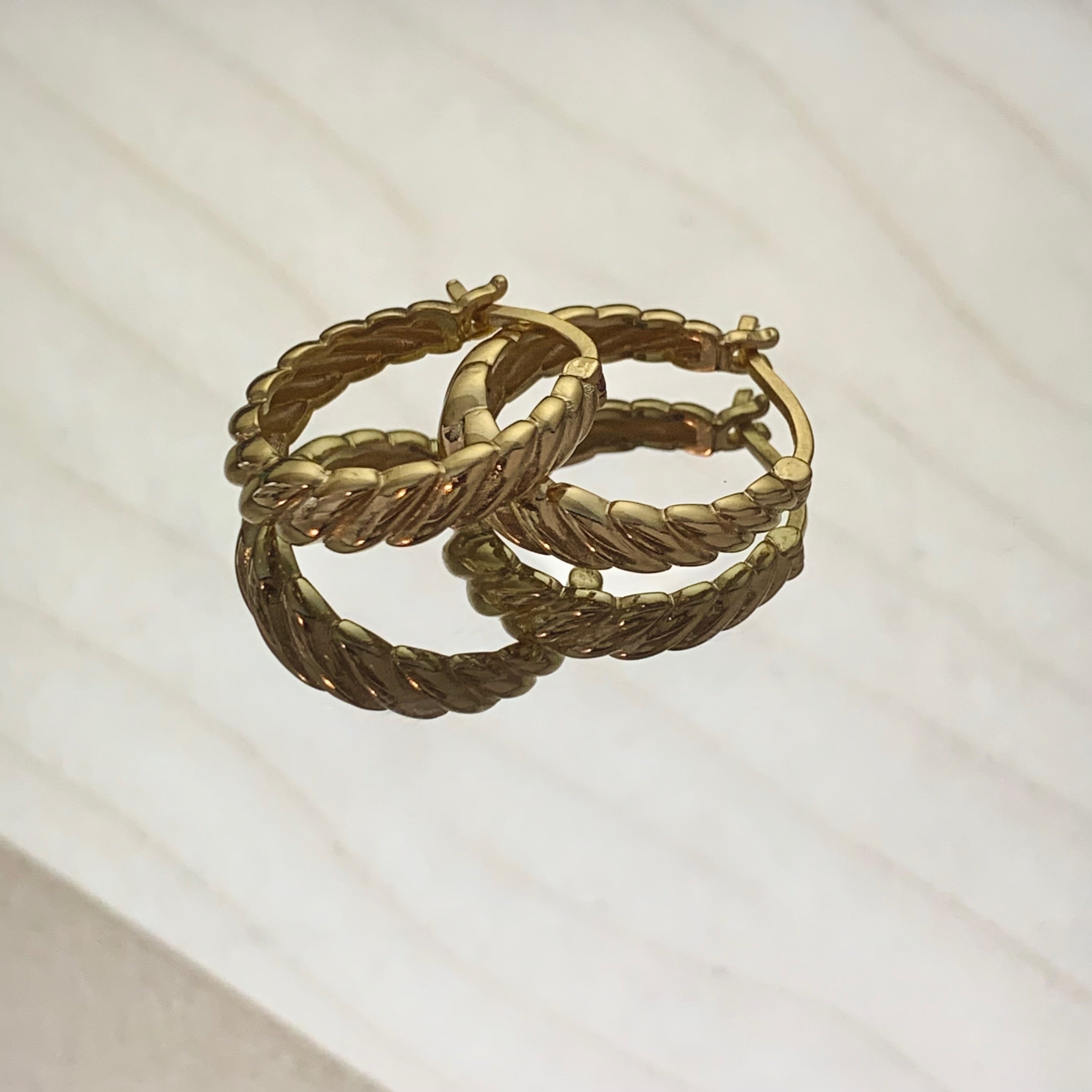 Gold twisted side ring earrings with polished finish