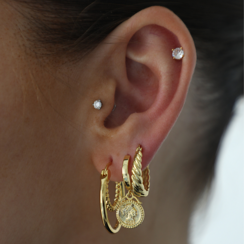Gold twisted side ring earrings with polished finish