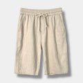 Beige men's relaxed fit shorts with a fluid silhouette and clean mid-rise waist