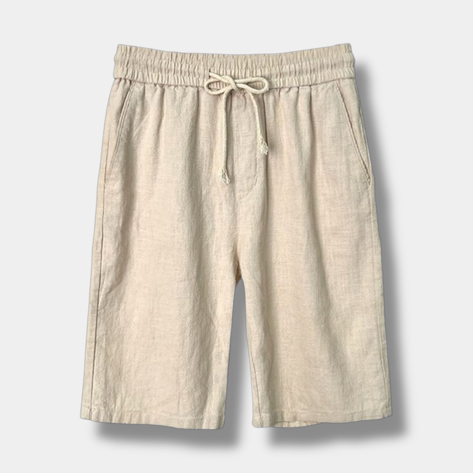 Beige men's relaxed fit shorts with a fluid silhouette and clean mid-rise waist