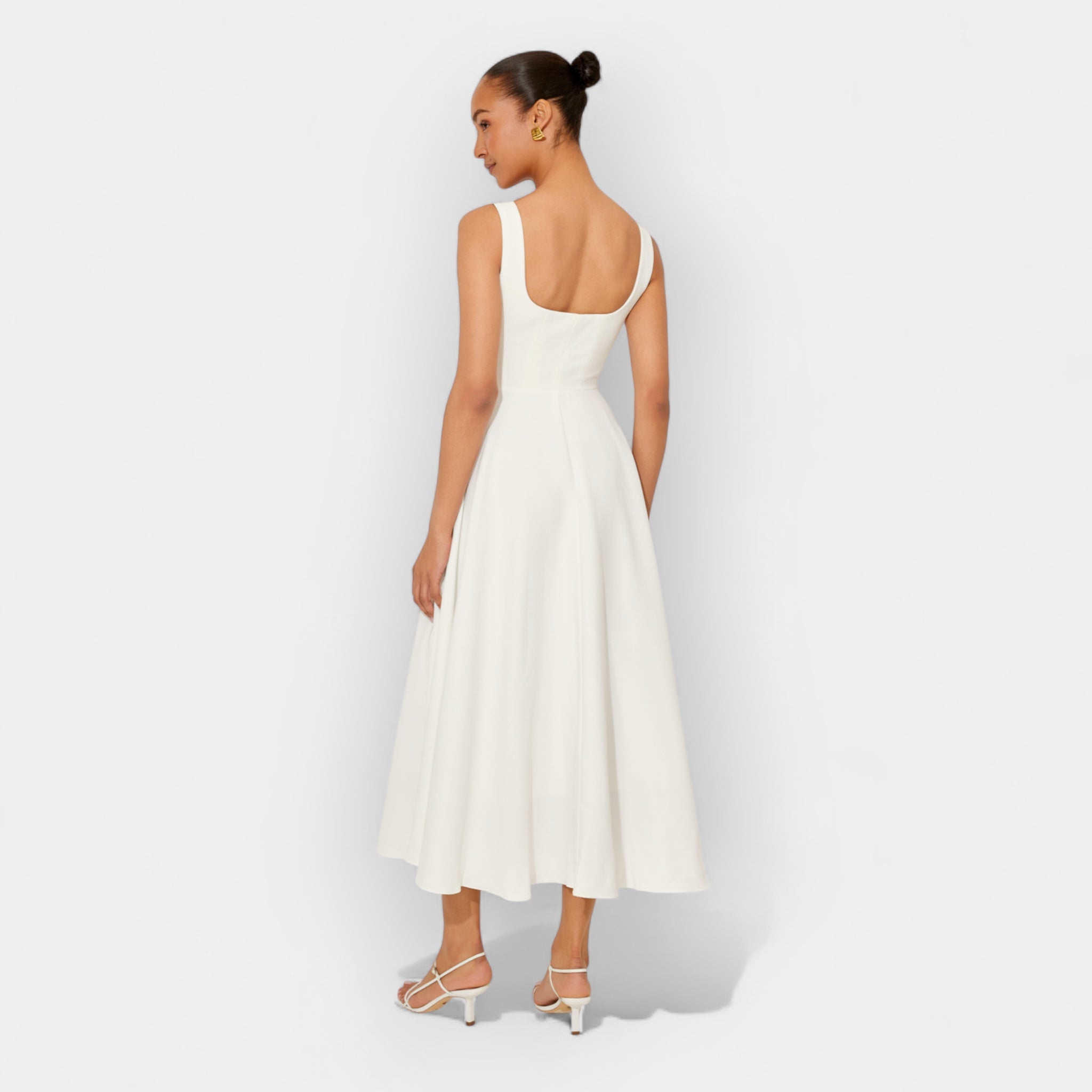 Elegant white midi A-line dress with a square neckline and flowing feminine skirt