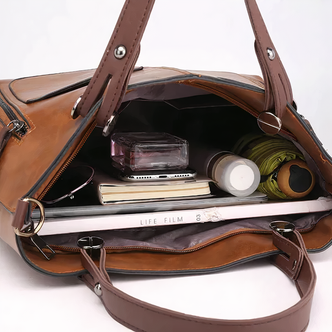 A woman holding a versatile classic handbag with a rich finish by her side