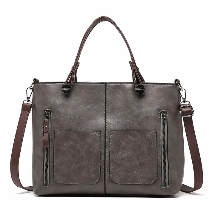 A woman holding a versatile classic handbag with a rich finish by her side