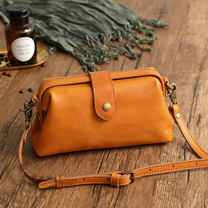 A woman carrying a trendy shoulder bag with a rich finish over one shoulder