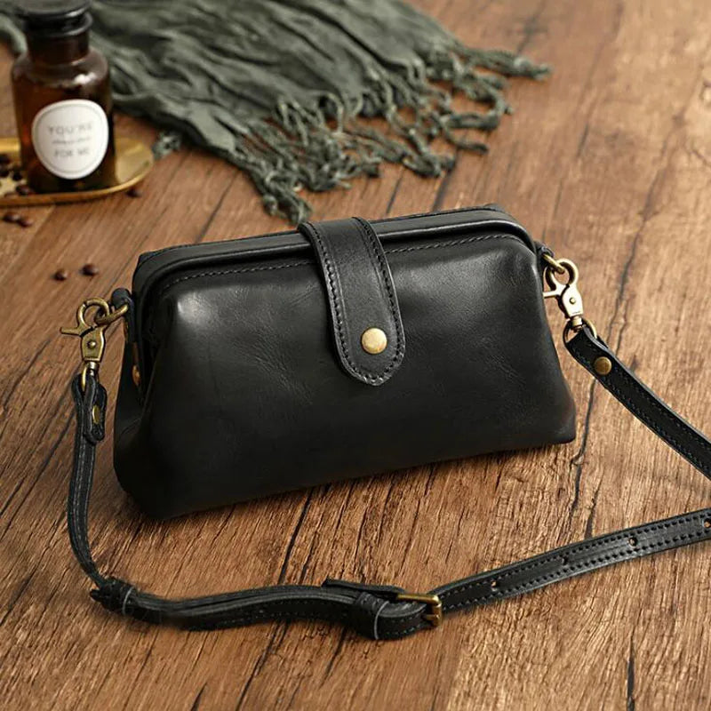 A woman carrying a trendy shoulder bag with a rich finish over one shoulder