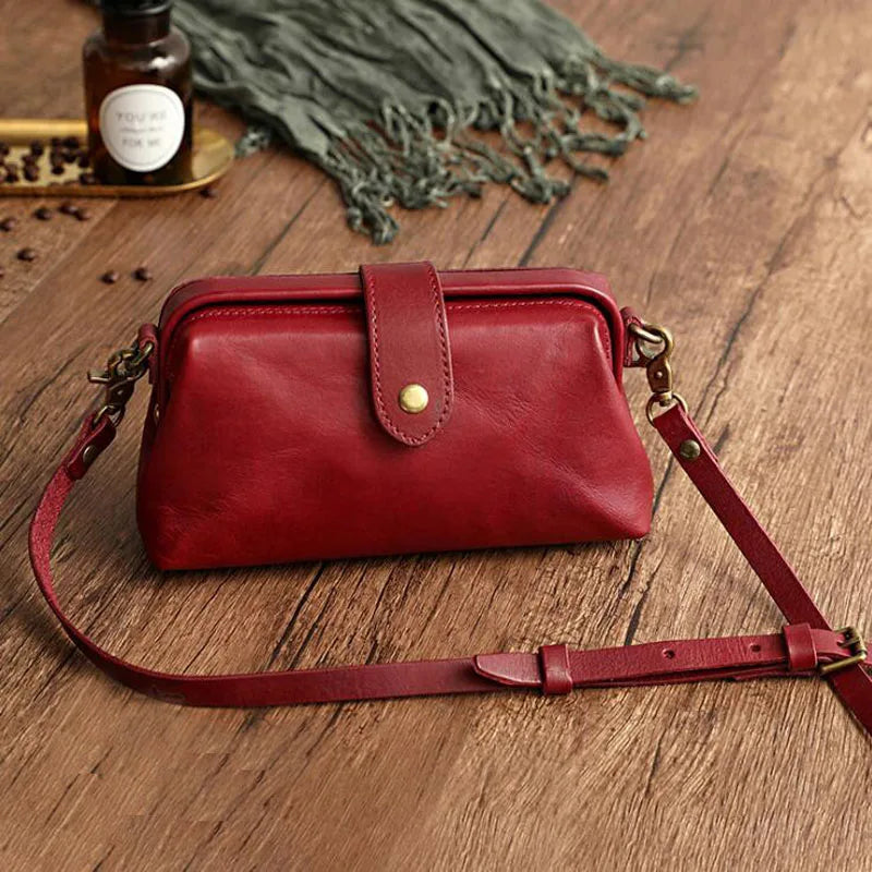 A woman carrying a trendy shoulder bag with a rich finish over one shoulder