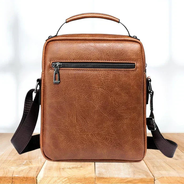A woman carrying a roomy light brown practical handbag on her shoulder during a busy day out.
