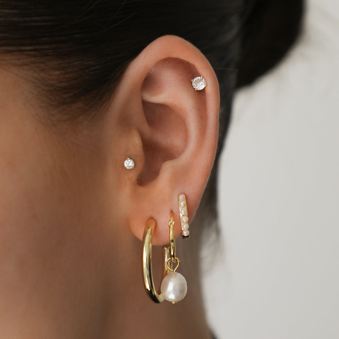 Gold sun pendant drop earrings with polished finish