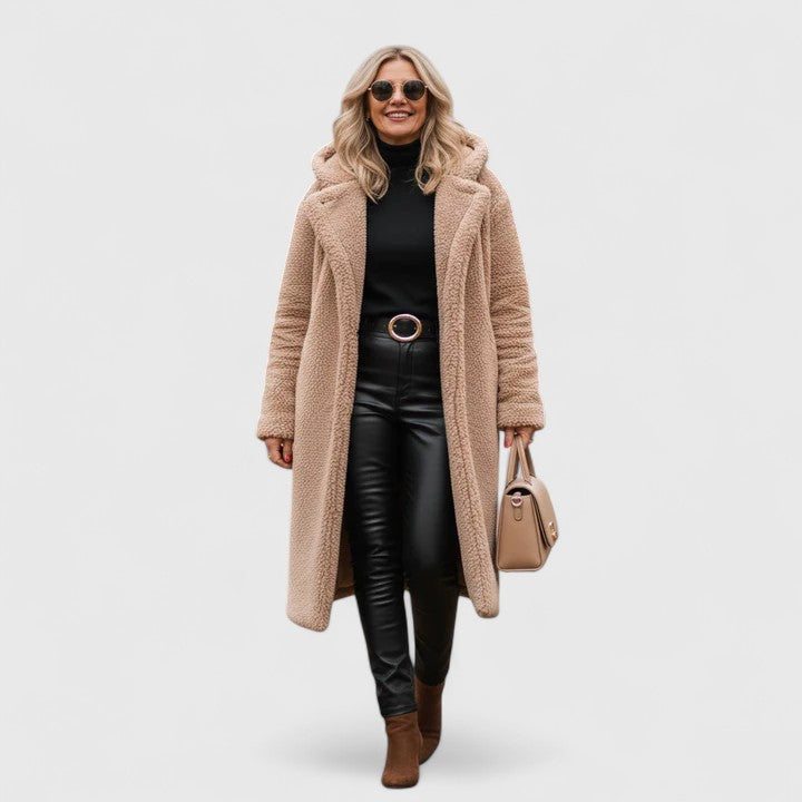 A woman wearing an elegant winter jacket on a cold day in town