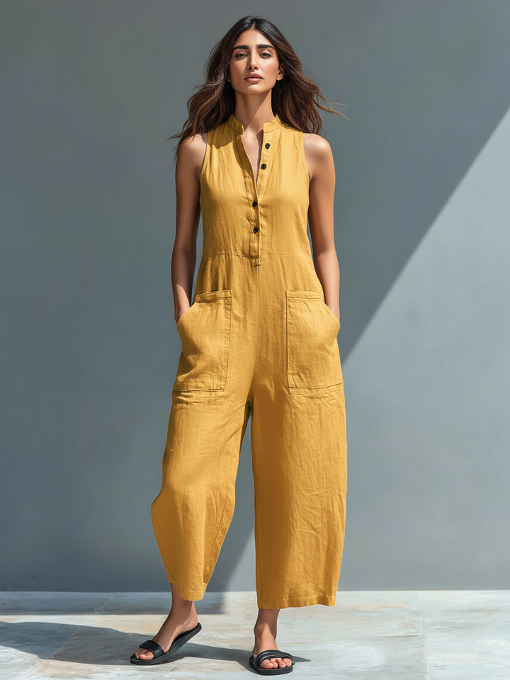 Minimalist white jumpsuit with front button detail and a relaxed fluid silhouette