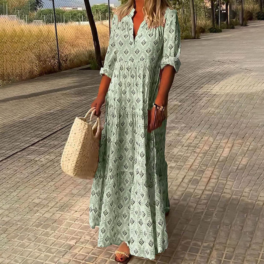 Woman wearing the Imelda™ elegant boho maxi dress with a V-neckline and flowing skirt at a summer occasion.