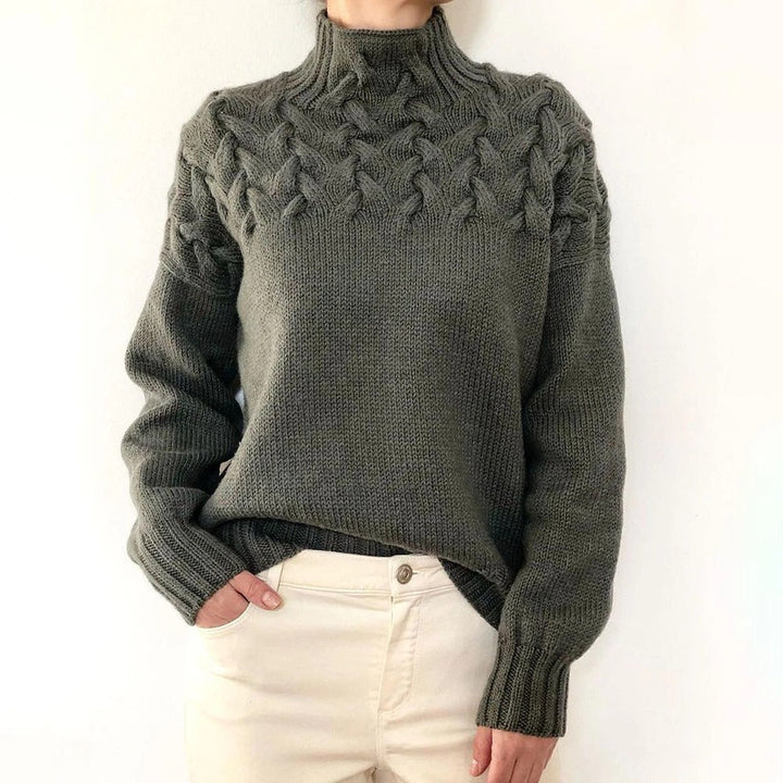 A woman wearing a warm roll-neck jumper, cosy and elegant on a cold winter day.