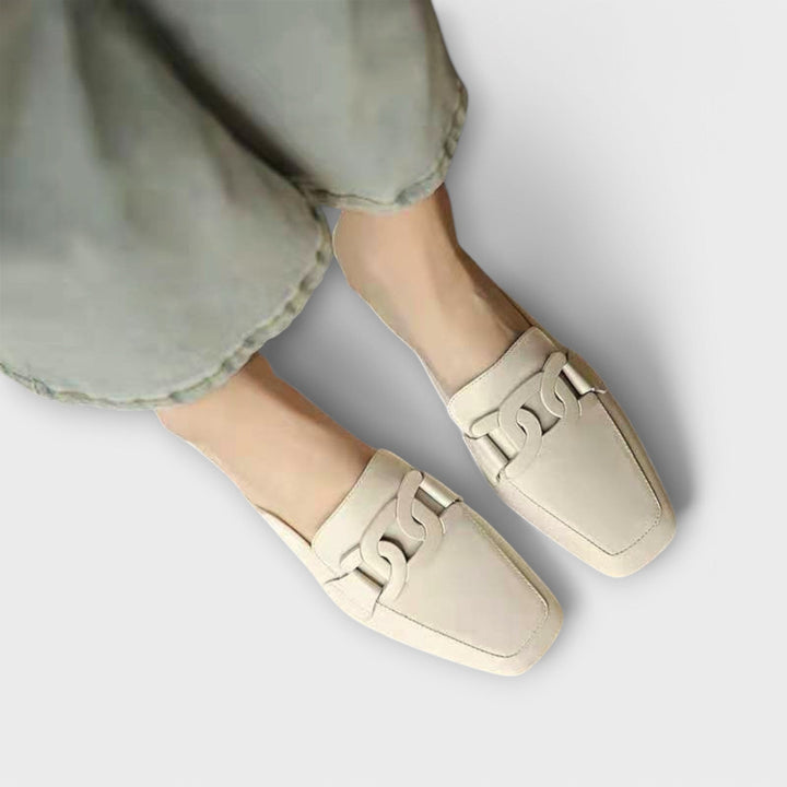 A woman in soft everyday slippers relaxing at home in the morning.