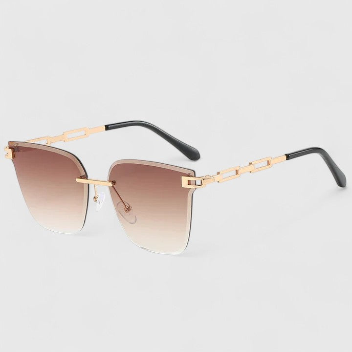 A woman wearing elegant cat-eye sunglasses with gradient lenses, glancing over her shoulder in the sun.