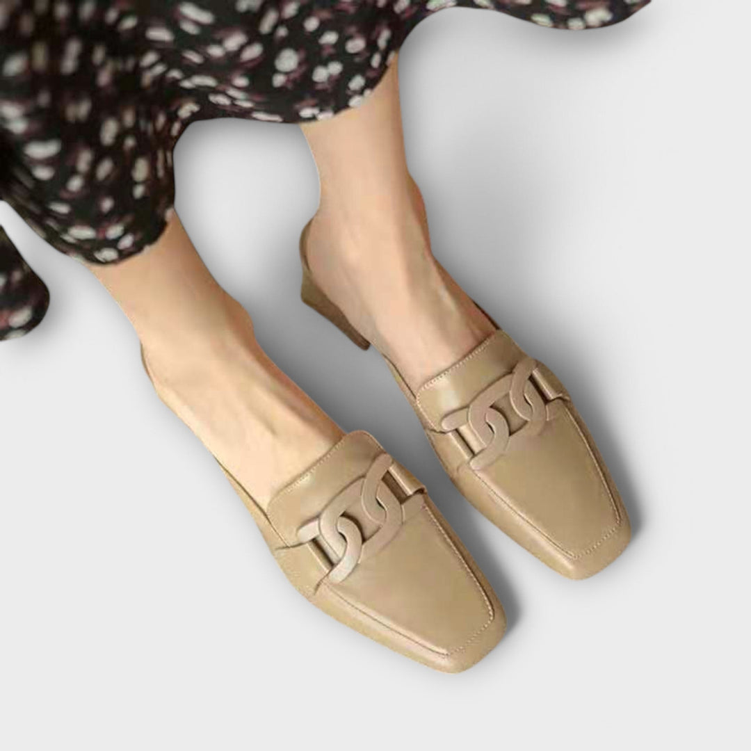 A woman in soft everyday slippers relaxing at home in the morning.