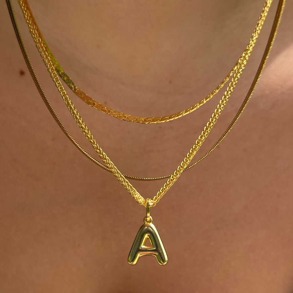 Layering necklace in gold and silver tones displayed on a clean background